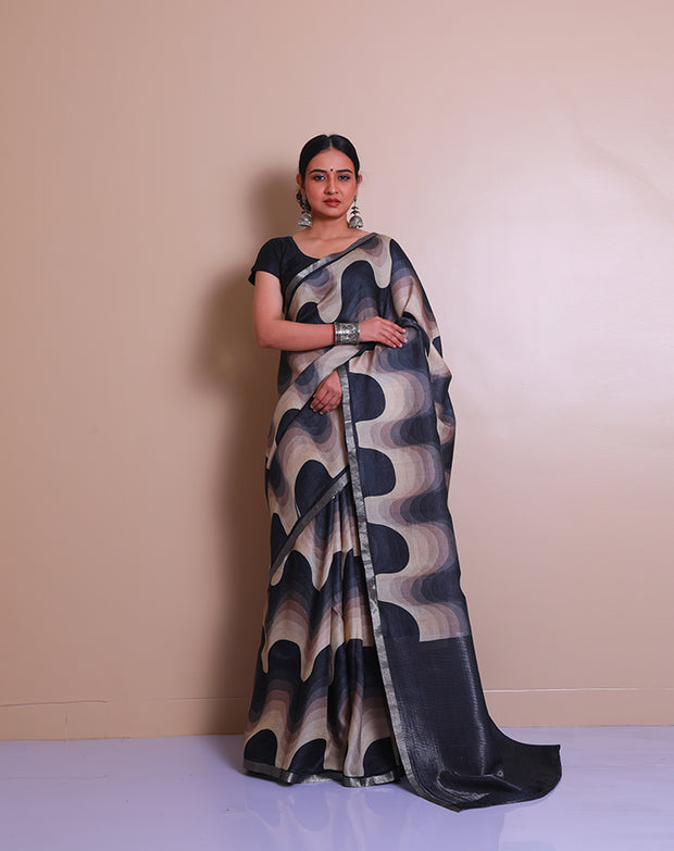 The black pure Tussar saree with modern print all over the drape, accented by a silver zari border - PTS05297