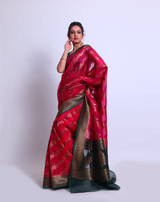 A Rani Pink organza Handloom saree with a contrast bottle green border and pallu featuring antique Zari sounds stunning - BSK010617