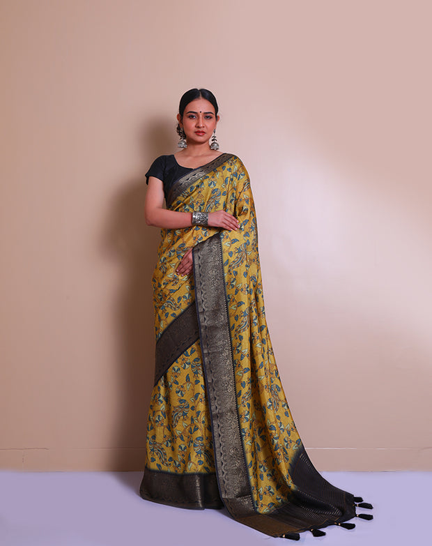 The mustard blended saree with Kalamkari print, featuring a zari border and pallu with tassels - BLN01331
