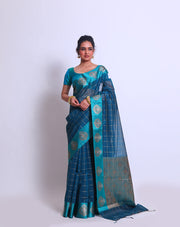 The Blue Fancy Cotton saree with Zari checks all over the drape and a Zari-woven pallu sounds absolutely exquisite - FCT011143