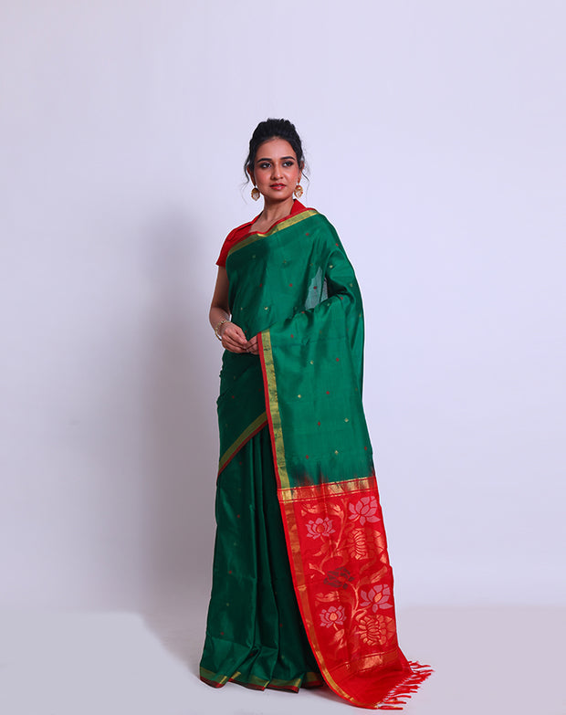 A Bottle Green Oppadda saree with Zari and red buttis all over the drape exudes elegance - OPD01739