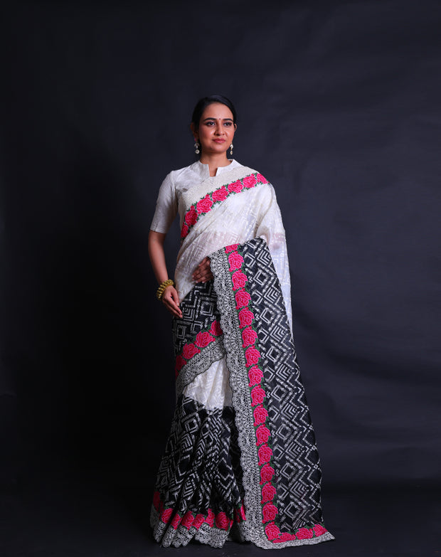 The black and white two-color organza saree with thread and zari embroidery featuring colorful rose flower design,- EMB03358