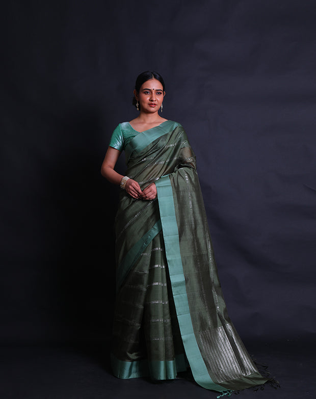 The dark green South silk saree with silver zari woven in geometric lines sounds striking,- KSL03119