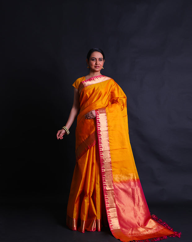 The mustard Kanjivaram soft silk saree with self buttis all over the drape sounds elegant and classic.- KSL02999