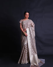 The grey kora saree adorned with thread and zari woven in Anand designs all over the drape,- BSK010529