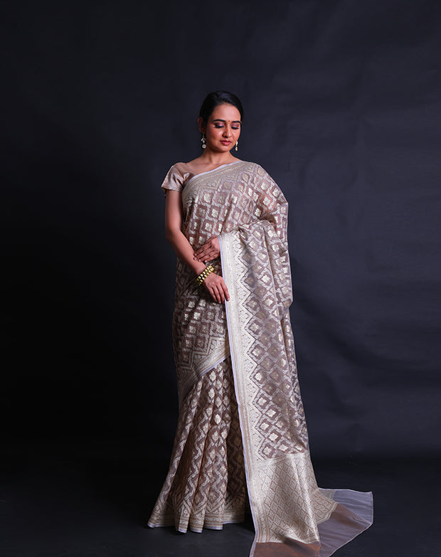 The grey kora saree adorned with thread and zari woven in Anand designs all over the drape,- BSK010529