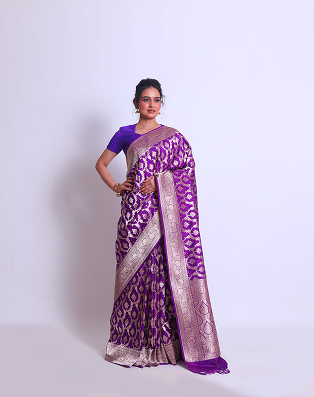 The Purple Banarsi Handloom Silk saree with a zari border and pallu woven with purple tassels must be absolutely enchanting - BSK010767
