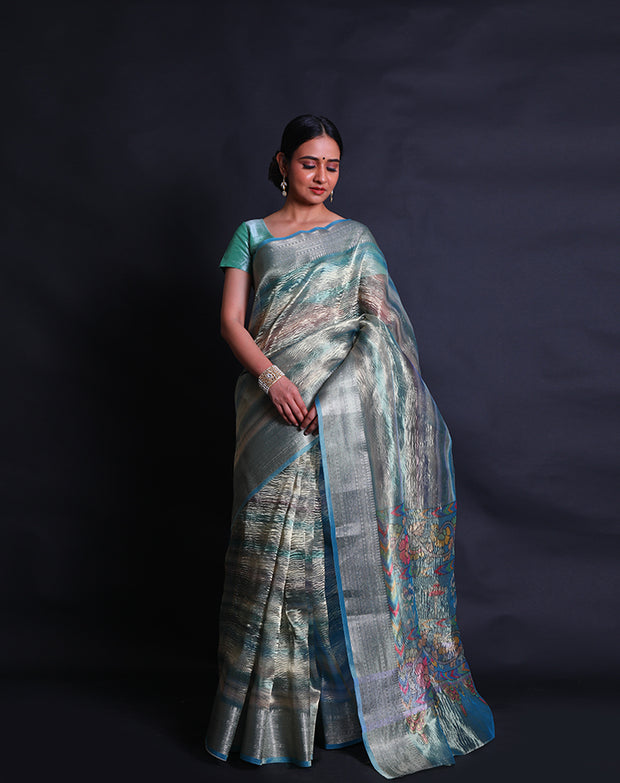 A multi-blended tissue saree features a zari border that adds a touch of sophistication to the ensemble. - FCT011107