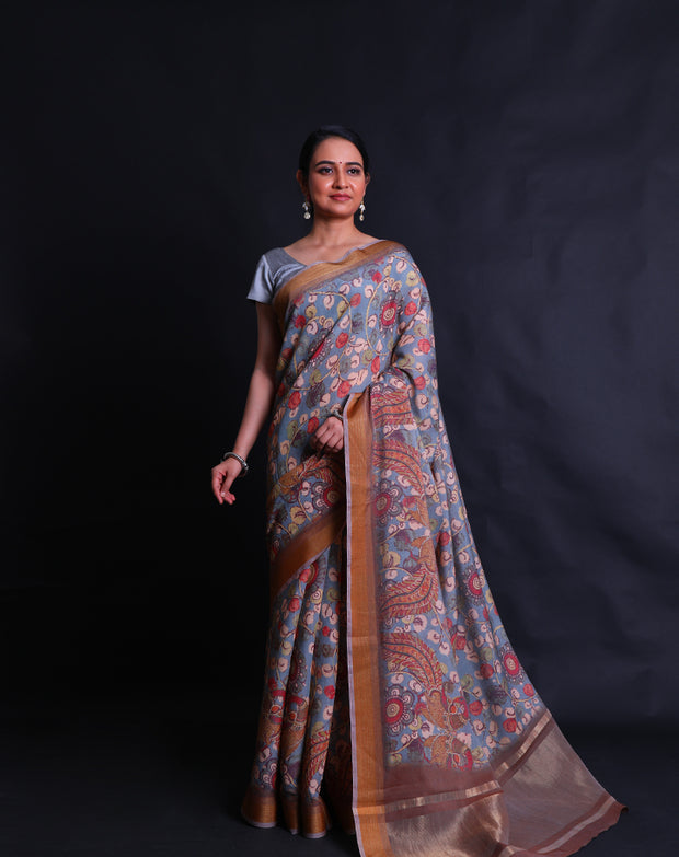 The light blue blended saree with Kalamkari print all over the drape sounds absolutely charming,- BLN00972