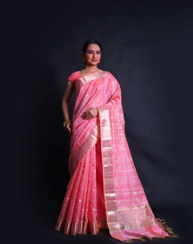 The peach cotton saree with silver zari lines and flower design all over the drape sounds elegant and charming.- FCT011146