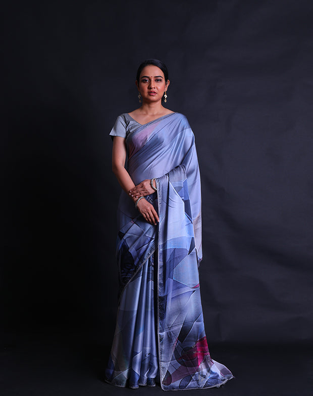 The grey blended satin crepe saree with different colors in digital modern print and stone embroidery all over the drape,- BLN01368