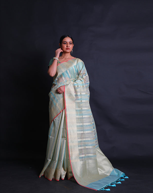 A fancy cotton light blue saree features zari lines woven all over the drape, - FCT011113