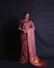 The pink Banarasi saree you're describing is adorned with antique zari woven throughout the drape,- BSK010674