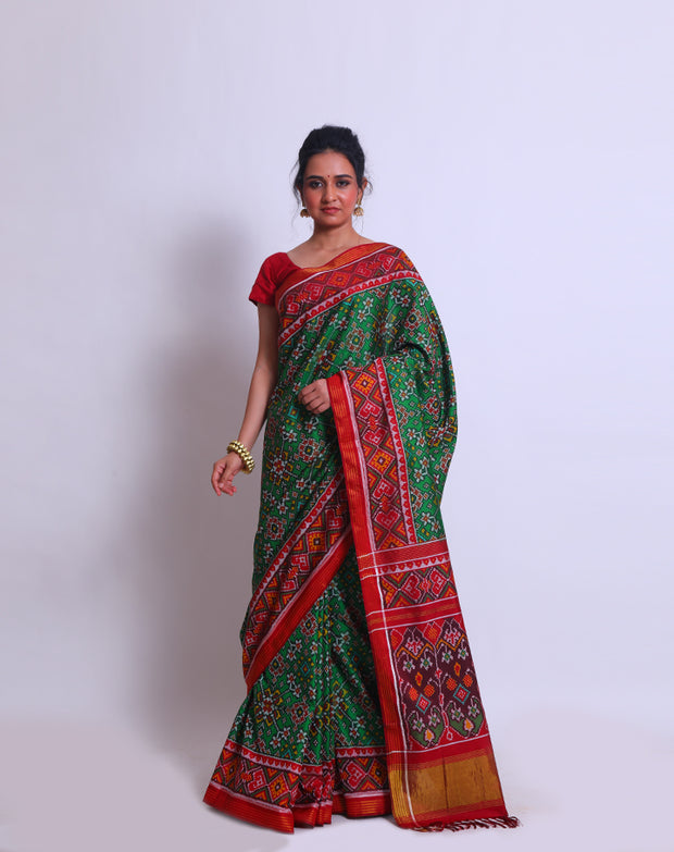 A green double Patola silk saree with a contrast maroon Patola design on the border and pallu must create a striking look - RPT00797