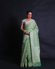 The green cotton saree with thread woven buttis all over the drape sounds elegant and versatile.- FCT011110