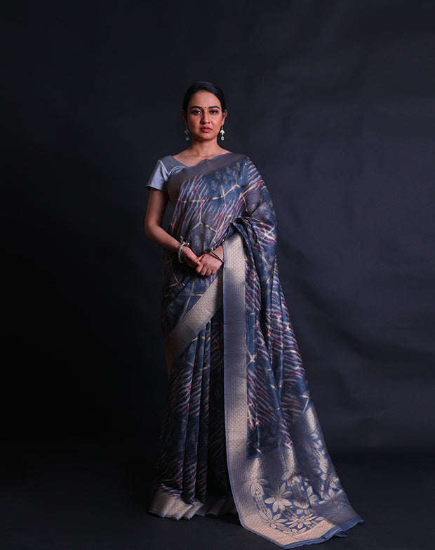 The dark grey blended saree with print all over and zari lines woven throughout the drape,- BLN01275