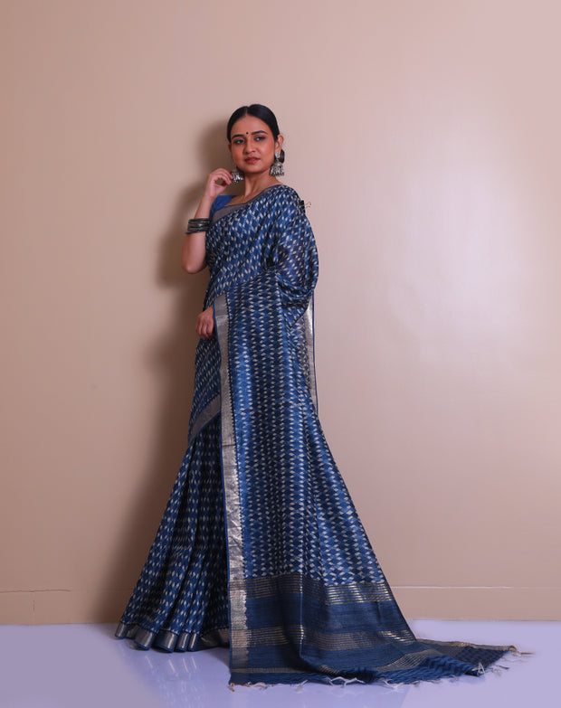 The indigo Tussar printed saree with a zari border and pallu sounds like a contemporary take on traditional elegance. - PTS05288