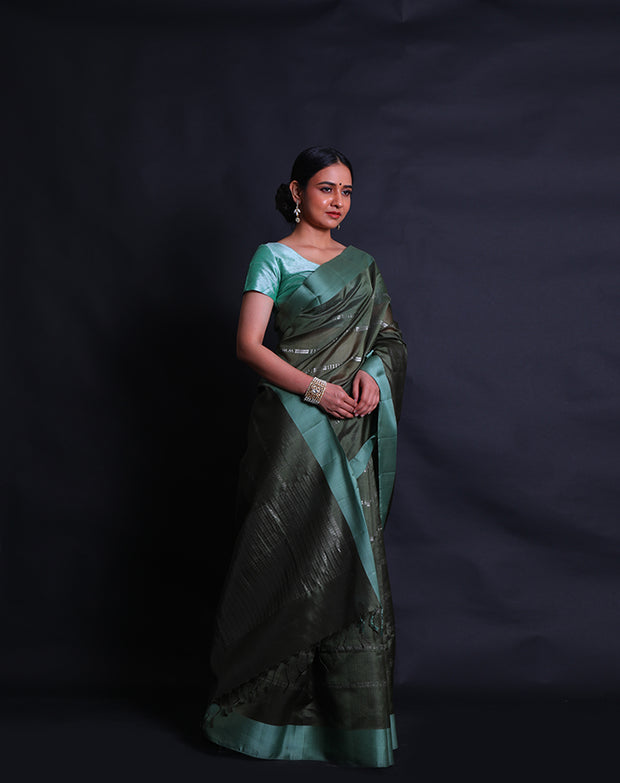 The dark green South silk saree with silver zari woven in geometric lines sounds striking,- KSL03119