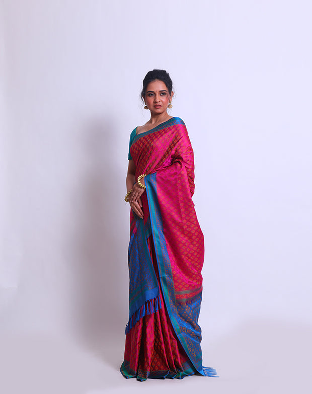 The combination of Pink Banarsi silk with a contrast blue border and pallu - BSK09553