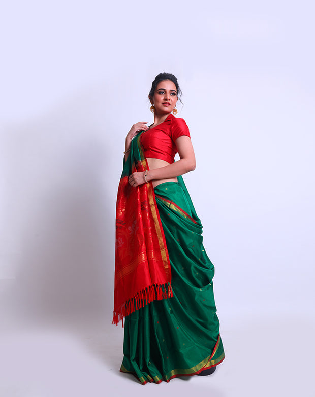 A Bottle Green Oppadda saree with Zari and red buttis all over the drape exudes elegance - OPD01739