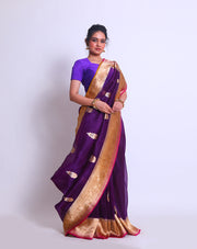 The Purple Organza Handloom saree with a combination of gold border and pink selvage on the border and pallu sounds absolutely elegant - BSK010257