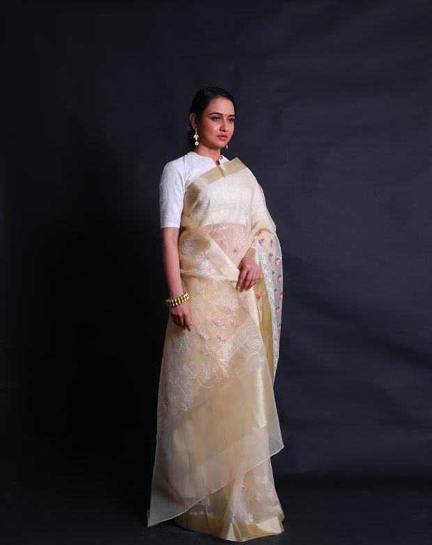 The light yellow organza saree with machine embroidery in white flower design all over the drape,- BLN01555