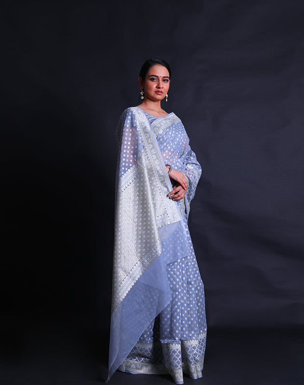 The light blue kora cotton saree adorned with zari and thread woven small buttis all over the drape,- BSK010448