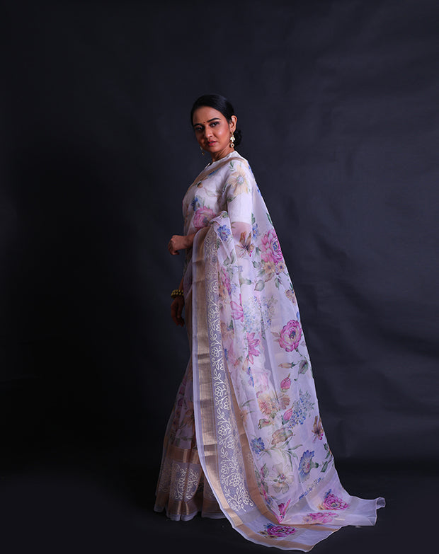 The pink organza saree with digital print in flower design all over the drape offers a modern and vibrant aesthetic.- BLN01555