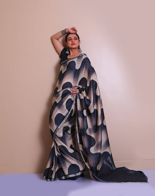 The black pure Tussar saree with modern print all over the drape, accented by a silver zari border - PTS05297