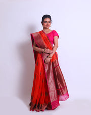 The Orange Organza Handloom saree with a contrast rani color border and pallu featuring antique zari weaving sounds stunning - BSK010449