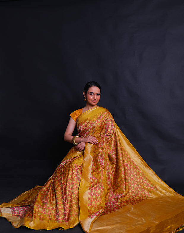 The green Banarasi silk saree with multi-colored woven design all over the drape.- BSK010580