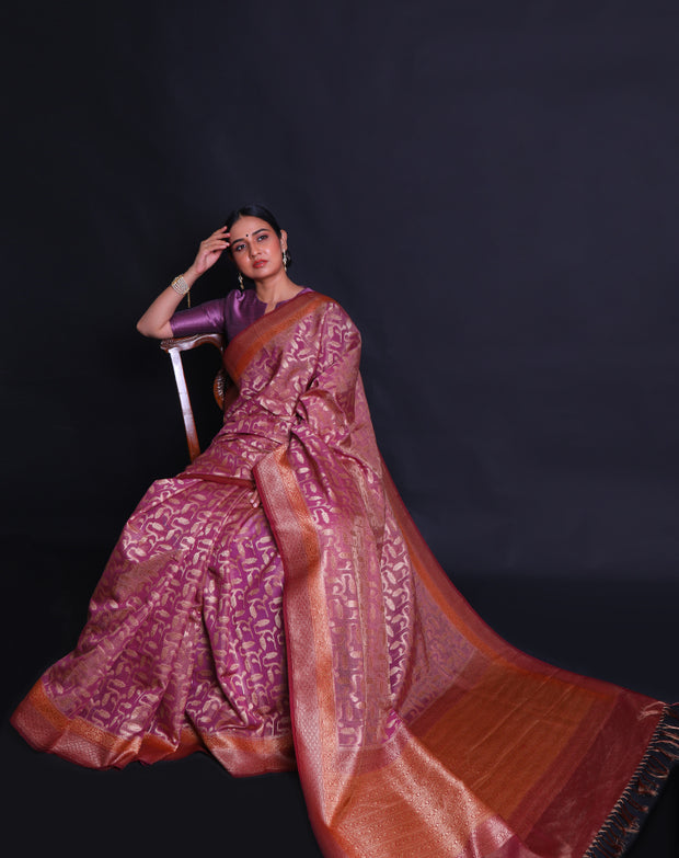 The pink Banarasi saree you're describing is adorned with antique zari woven throughout the drape,- BSK010674