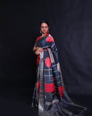 The black Desi Tussar saree featuring a zari border and pallu exudes timeless elegance.- PTS05292