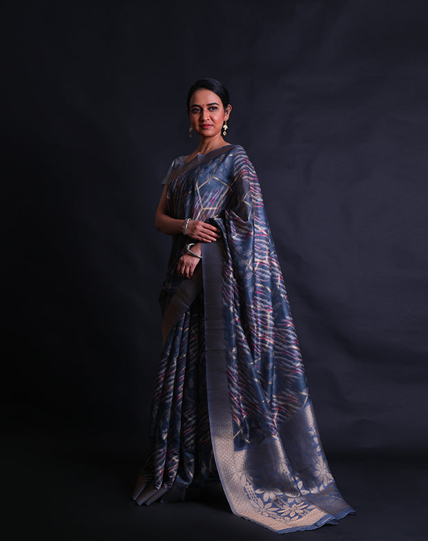 The dark grey blended saree with print all over and zari lines woven throughout the drape,- BLN01275
