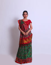 A green double Patola silk saree with a contrast maroon Patola design on the border and pallu must create a striking look - RPT00797