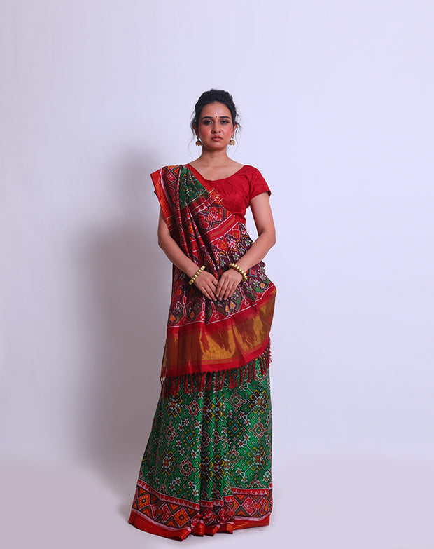 A green double Patola silk saree with a contrast maroon Patola design on the border and pallu must create a striking look - RPT00797