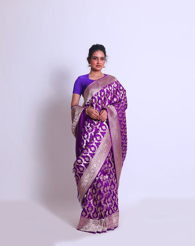 The Purple Banarsi Handloom Silk saree with a zari border and pallu woven with purple tassels must be absolutely enchanting - BSK010767