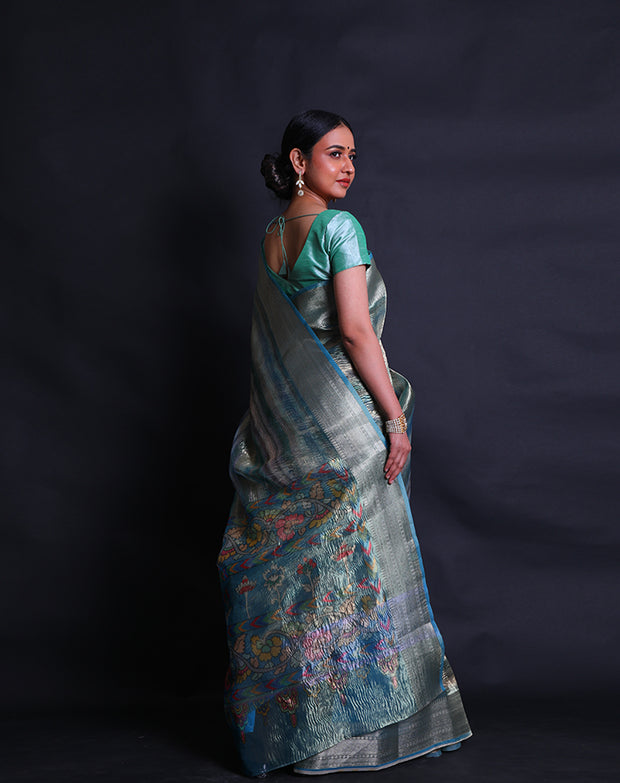 A multi-blended tissue saree features a zari border that adds a touch of sophistication to the ensemble. - FCT011107