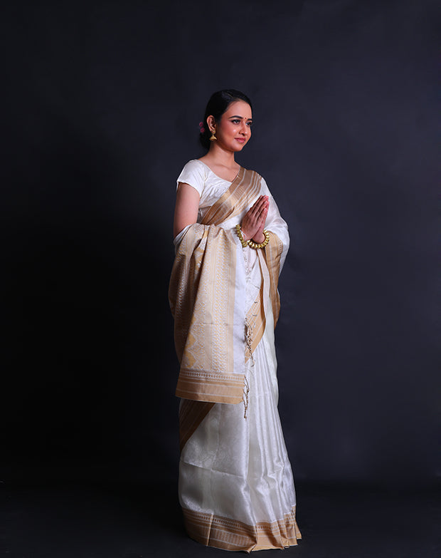 The white silk Kota saree with self design woven and beige thread woven in the border and pallu,- KSL03047