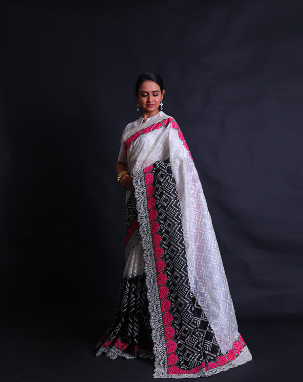 The black and white two-color organza saree with thread and zari embroidery featuring colorful rose flower design,- EMB03358