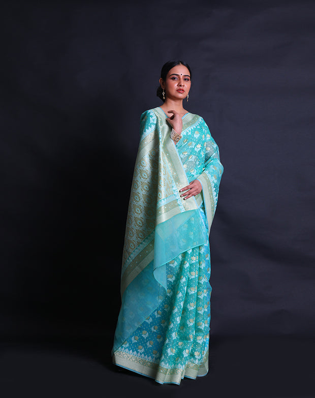 The sea green kora cotton saree with lotus and leaf designs woven in thread and zari sounds exquisite, - BSK010448