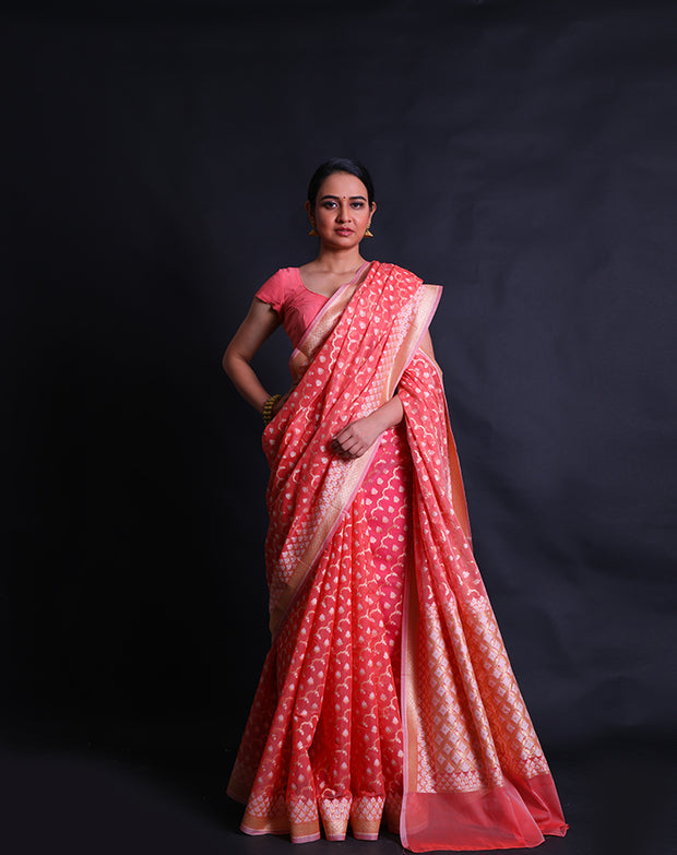 The peach kora cotton saree with zari and thread woven in different designs.- BSK010448