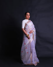 The light mauve organza saree with thread machine embroidery in white and colorful flowers all over the drape,- BLN01555