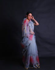 The grey blended organza saree with handprint in a colorful way, along with gold lines hand-printed in a modern attire,- BLN01279