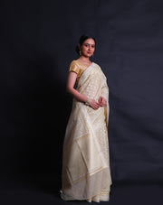 The beige kora cotton saree you described is adorned with white and zari thread woven all over the drape,- BSK010448