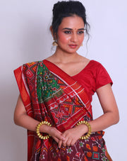 A green double Patola silk saree with a contrast maroon Patola design on the border and pallu must create a striking look - RPT00797
