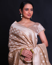 The beige Banarasi linen Khadi georgette saree adorned with silver zari buttis all over the drape,- CHG04026