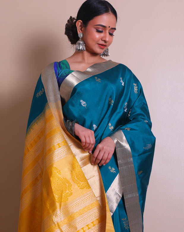 The peacock blue Kanjivaram saree with a gold and silver zari border sounds absolutely regal. - KSL03070