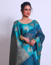 The Blue Fancy Cotton saree with Zari checks all over the drape and a Zari-woven pallu sounds absolutely exquisite - FCT011143