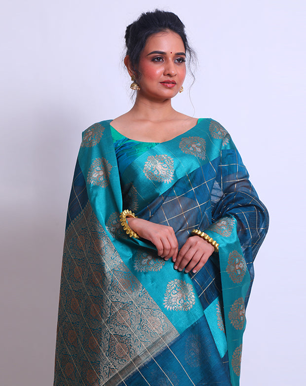 The Blue Fancy Cotton saree with Zari checks all over the drape and a Zari-woven pallu sounds absolutely exquisite - FCT011143